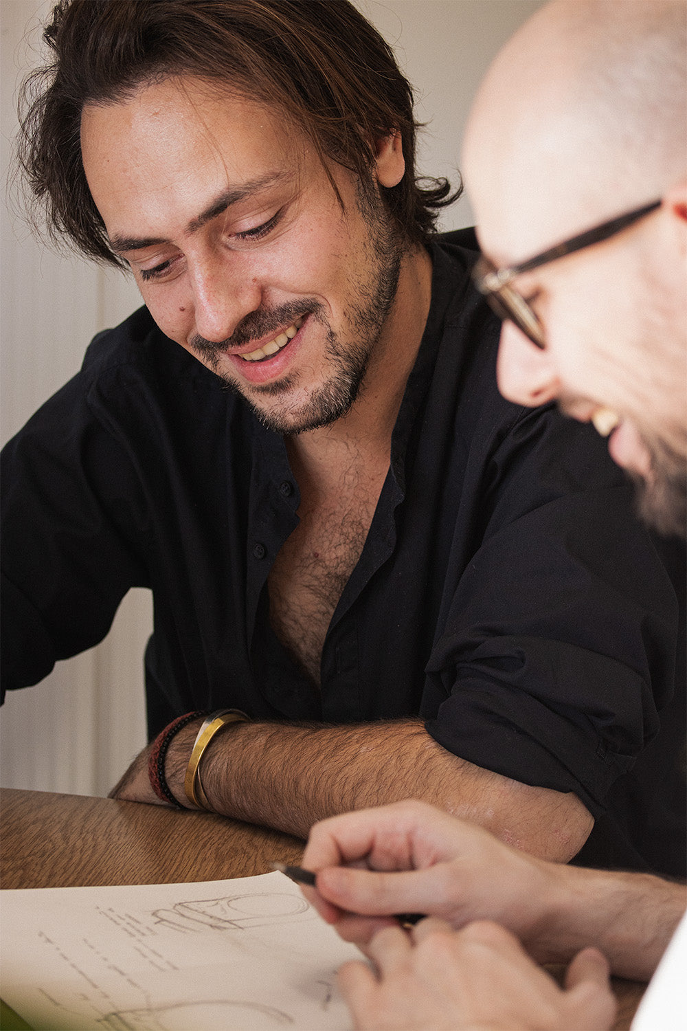 A man crafting a surprise engagement ring for his partner during a private, one-on-one jewelry making workshop at Amaré's Lisbon studio.