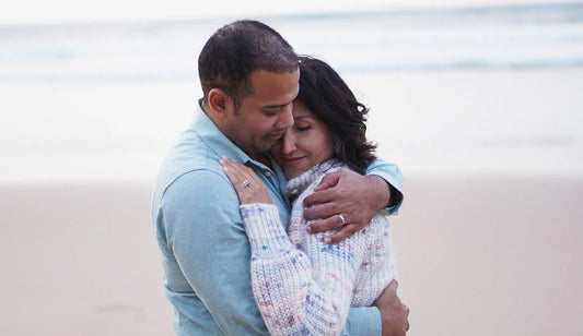 Romantic beach proposal in Lisbon, Portugal with a couple embracing by the ocean