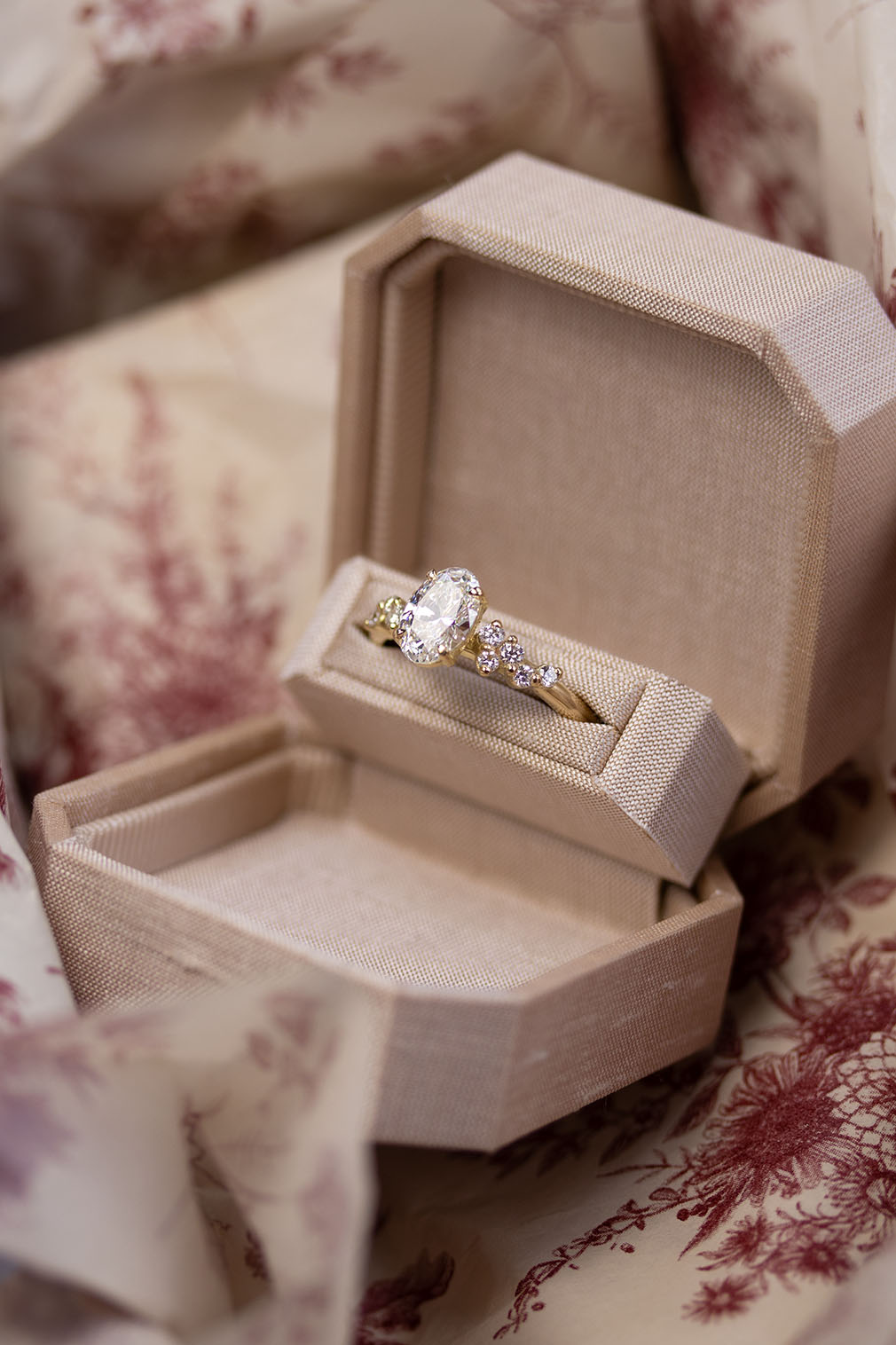 Gold ring with a diamond in an open beige jewelry box in Lisbon atelier