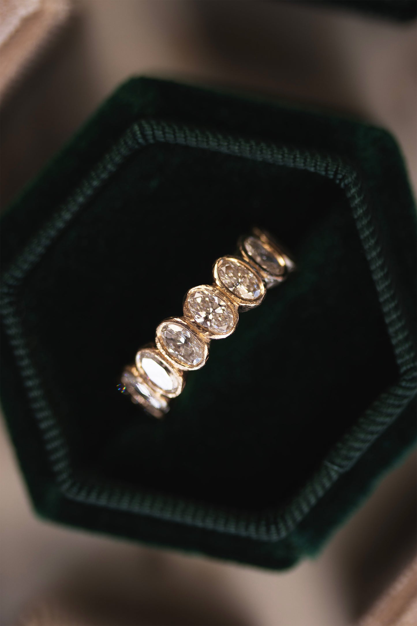 Handcrafted oval diamond bezel eternity ring in solid yellow gold by Amaré Jewelry Lisbon